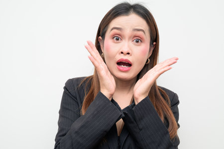 Studio portrait of an Asian business woman wearing a black blazer against a white background. Professional and confident look suitable for corporate, office, career, and workplace themes.の写真素材