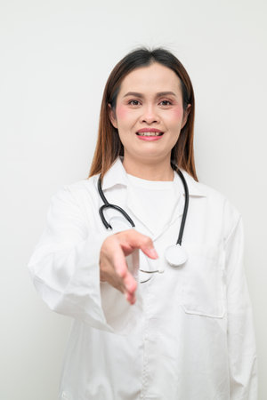 Studio portrait of an Asian healthcare professional wearing a white coat and stethoscope. Concept suitable for medical, hospital, clinic, and healthcare themes.の写真素材