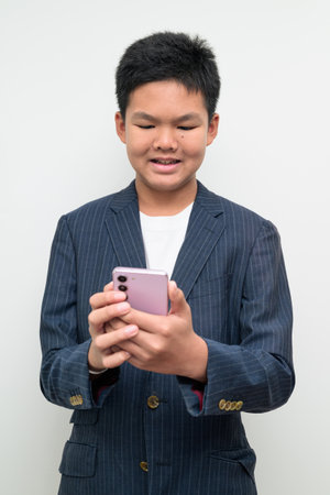 Studio portrait of an Asian teenage boy wearing a formal suit against a white background. Suitable for business, education, leadership, career, and future success themes.の写真素材