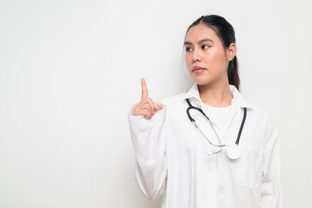 Portrait of a female healthcare professional in a white medical uniform with a stethoscope, standing against a clean studio background. Suitable for medical, hospital, and clinical themes.の写真素材