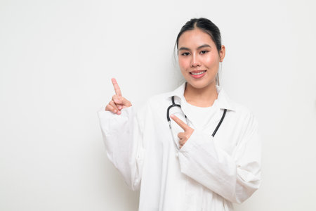 Portrait of a female healthcare professional in a white medical uniform with a stethoscope, standing against a clean studio background. Suitable for medical, hospital, and clinical themes.の写真素材