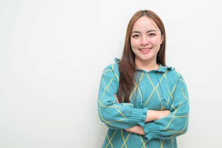 Studio portrait of a young Asian woman against white backgroundの写真素材