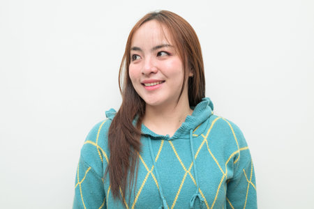 Studio portrait of a young Asian woman against white backgroundの写真素材