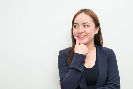 Studio portrait of a young Asian businesswoman against white backgroundの写真素材