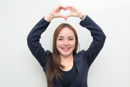 Studio portrait of a young Asian businesswoman against white backgroundの写真素材