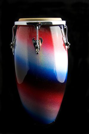 A silver, red, and blue Latin or African conga  drum isolated against a  black background with copy space.の写真素材