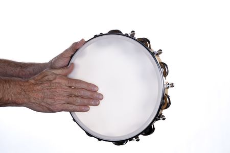 A tambourine being played by a manÕs hands isolated against a white background.の写真素材