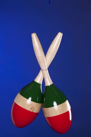 A set of Latin maracas percussion music instruments isolated against a blue background.の写真素材