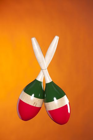 A set of Latin African maracas isolated against a yellow gold background in the vertical format.の写真素材