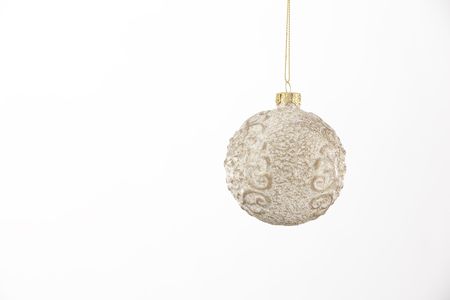 A cream colored Christmas ornament isolated against a white background.の写真素材