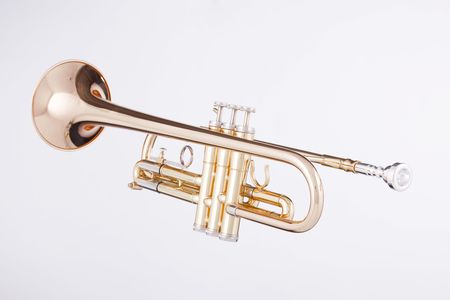 A gold trumpet isolated against a white background in the horizontal format.の写真素材