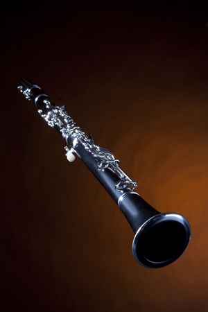 A soprano clarinet isolated against a gold spotlight background in the vertical format.の写真素材