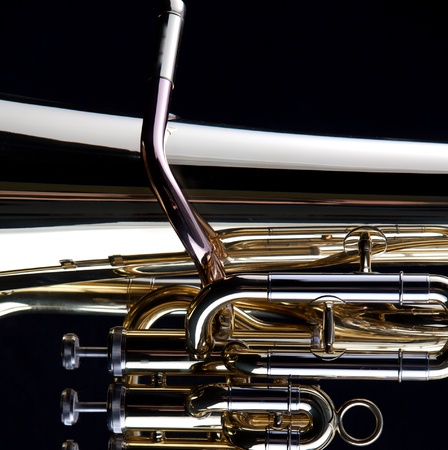 A gold brass tuba euphonium isolated on a black background in the square format with copy space.の写真素材