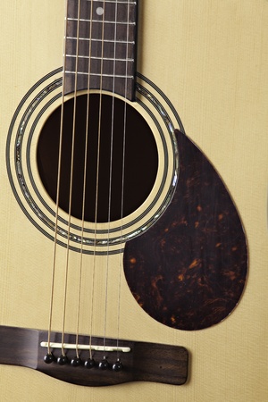 A natural finish acoustic guitar isolated close up and sharp.の写真素材