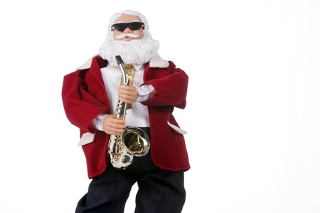 A toy Christmas Santa Clause plying saxophone isolated against a white background.の写真素材