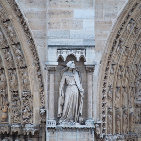 Sculptures on facade of Notre Dame (catholic cathedral) in Paris, France.の写真素材