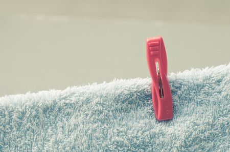 Red clothespin on the blue towelの写真素材