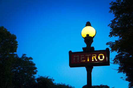 Metro sign for subway at night in Paris, Franceの写真素材
