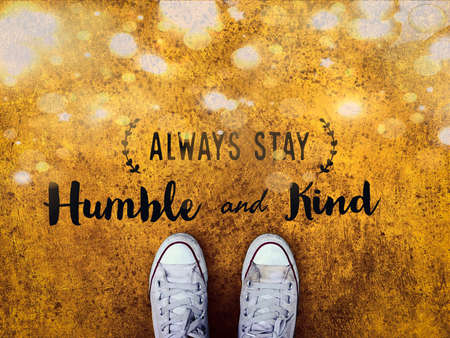 Always stay humble and kind word on white sneakers shoe yellow sparkle backgroundの写真素材