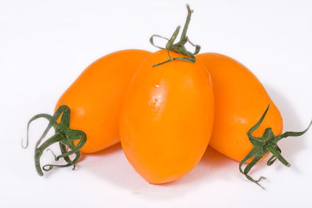 fresh yellow tomatoes over whiteの写真素材