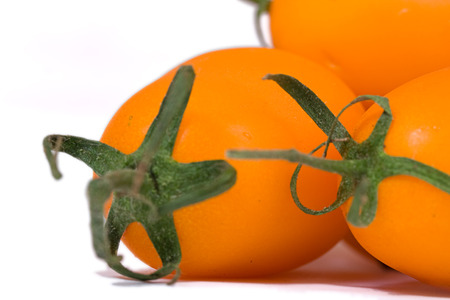 fresh yellow tomatoes over whiteの写真素材