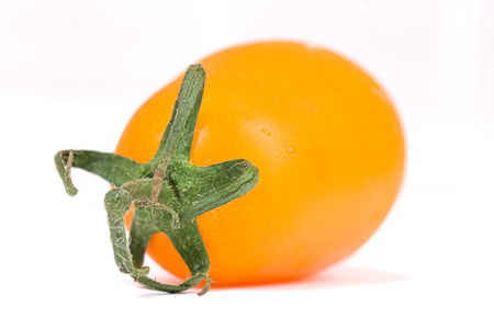 fresh yellow tomato over whiteの写真素材