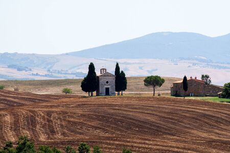 Tuscany landscape with Chapel and cypresses - Italyの写真素材