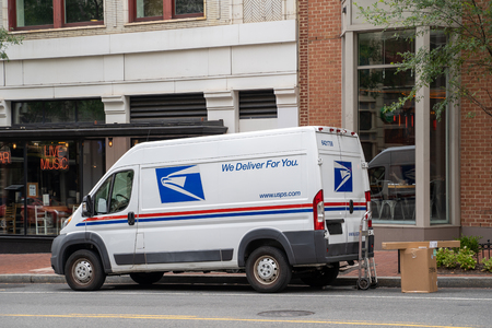 Washington, DC - August 5, 2019: A USPS (United States Postal Service) van is parked outside on a downtown Washington DC street, delivering packages and mailのeditorial素材