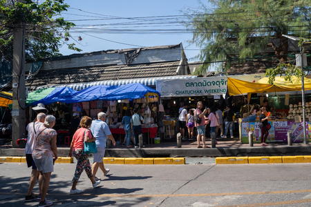 Bangkok, Thailand - November 30, 2019:  Shoppers cross the street to enter the famous Chatuchak Weekend Market to visit all of the vendors and stallsのeditorial素材
