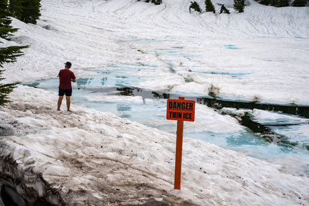 Lassen National Park, California - July 9, 2019: Tourist clearly ignoring the Danger Thin Ice...