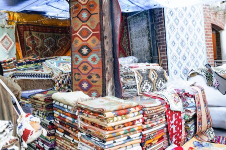 New Delhi, India - November 17, 2019: Rugs sold at a booth in Dilli Haat, an outdoor craft market bazaar showcasing handmade items from each Indian stateの写真素材