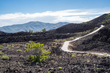 Spatter Cones trail, a paved walkway leading to a cinder cone wi in Craters of the Moon National...