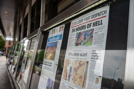 Washington, DC - August 5, 2019: Display of newspapers outside of the Newseum, a journalism museum. Newspapers show the headlines of recent mass shootings in El Paso and Dayton OHのeditorial素材