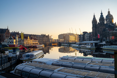 Amsterdam, Netherlands - November 9, 2019: Buildings and house boats along canal during an early autumn fall morning in the Jordaan neighborhoodのeditorial素材