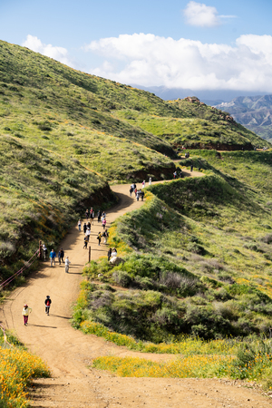 Lake Elsinore, California - March 22, 2019: Tourists and hikers walk along the trail of Walker Canyon during the Poppy wildflower superbloomのeditorial素材