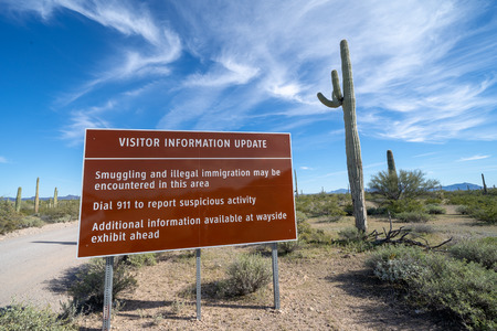 Sign at Organ Pipe National Monument, near the US and Mexico border, warns visitors to be aware of drug cartels and illegal immigration in the areaのeditorial素材