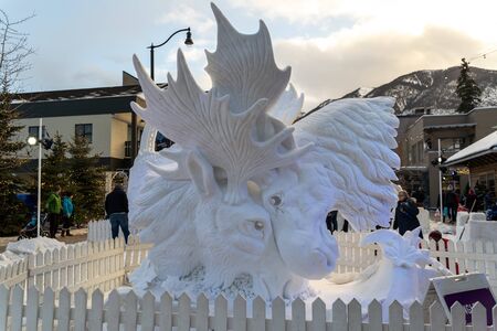 Banff, Alberta Canada - Jan. 19, 2019: Beautiful snow sculpture of two moose butting heads, at the Banff Snow Days International Snow Carving Competitionのeditorial素材