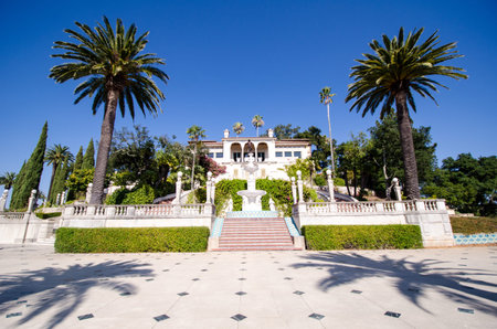 San Simeon, California - August 7, 2018: Exterior view of the Hearst Castle against a bright blue...