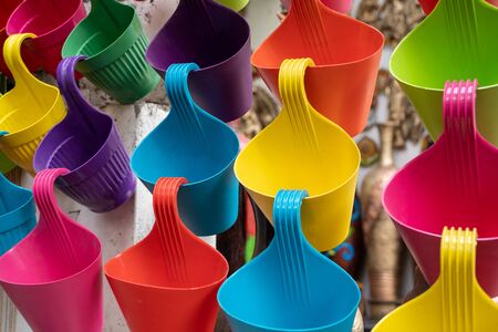 Colorful plastic planters on display at a home goods and decor market in New Delhi Indiaの写真素材