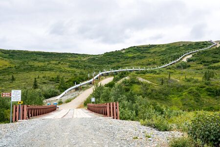 The Trans Alaska Pipeline runs uphill in the Phelan Creek area along the Richardson Highwayの写真素材