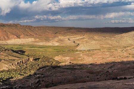 Wide angle view of Arches National Park during sunrise, with the winding road in the photoの写真素材