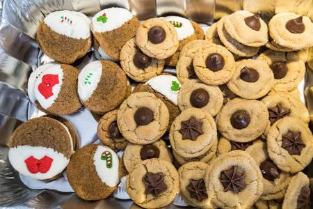 Pile of homemade Christmas cookies - peanut butter kisses (stars) and white chocolate dipped ginger...