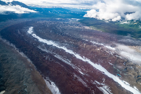 Beautiful aerial view of Root Glacier in Wrangell St. Elias National Park with wispy clouds in the...