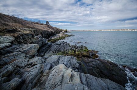 Rhode Island Cliff Walk shows breaking waves along the rocky shoreline of the Atlantic Oceanの写真素材