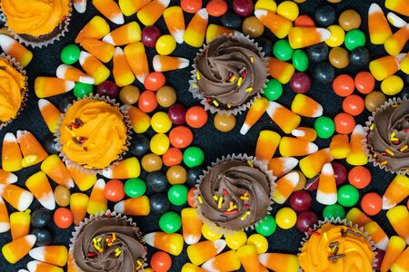 Close up view of Halloween candy corn and, cupcakes and chocolate candyの写真素材