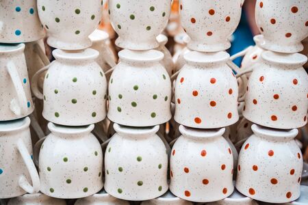 White polka dot speckled teacups or coffee cups for sale at the Surajkund Crafts Mela in Indiaの写真素材