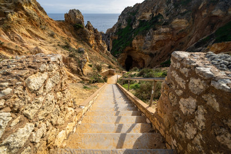 Steep steps leading down to explore the sea caves and ocean at Ponta da Piedade, in Algarve Portugal