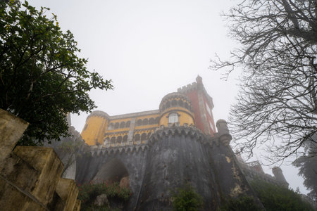 Extremely foggy view of the famous yellow Pena Palace during winter