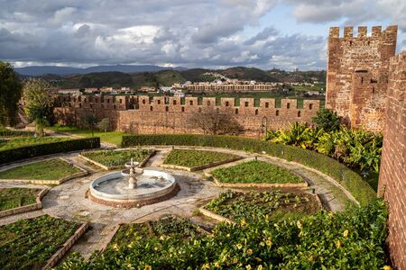 Silves, Portugal - January 23, 2020: View of the interior of the Silves Castle, from up on the castle walls, looking down at the garden courtyardのeditorial素材