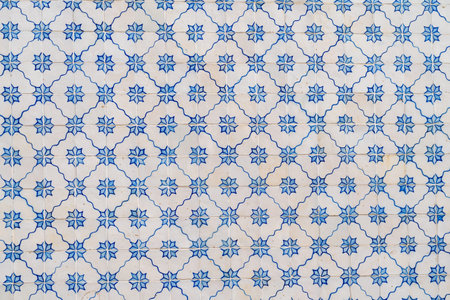 Ornate blue and white tiles on a building in Lisbon, Portugal